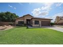 Charming single-story home featuring a well-manicured lawn and a two-car garage at 17806 N 54Th Ln, Glendale, AZ 85308