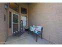Inviting front porch with welcome decor, bench seating and decorative pillows at 17806 N 54Th Ln, Glendale, AZ 85308