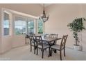 Elegant dining room boasts a chandelier and large windows at 17939 N Encanto Dr, Surprise, AZ 85374