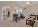 Inviting living room with leather chairs and view to the kitchen and bright rooms at 17939 N Encanto Dr, Surprise, AZ 85374