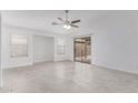 Bright living room features neutral decor, a ceiling fan, and sliding glass doors to the backyard patio at 2629 E Beverly Rd, Phoenix, AZ 85042