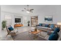 Bright living room features neutral decor, a ceiling fan, and sliding glass doors to the backyard patio at 2629 E Beverly Rd, Phoenix, AZ 85042