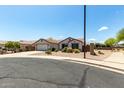 Street view of a cozy single-Gathering home with desert landscaping, complemented by the surrounding neighborhood ambiance at 30 S 230Th Ave, Buckeye, AZ 85326