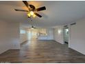 Open living room featuring wood flooring, with a view of kitchen and back patio at 3150 E Corrine Dr, Phoenix, AZ 85032