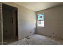 Bedroom featuring a window, drywall walls, concrete floor, and an open closet at 32123 N Lone Rancher Way, San Tan Valley, AZ 85140