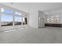 Bright, open living room with large windows offering scenic views and tile flooring at 32497 N 135Th Dr, Peoria, AZ 85383