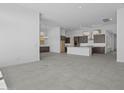 Open floorplan with a kitchen island, modern appliances and tile flooring at 32497 N 135Th Dr, Peoria, AZ 85383