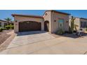 Single-story home featuring desert landscaping, a two-car garage and beige house paint at 35756 N Clementine Trl, San Tan Valley, AZ 85140