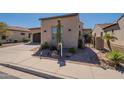 Attractive desert landscaping with a towering Saguaro cactus and beige house paint at 35756 N Clementine Trl, San Tan Valley, AZ 85140