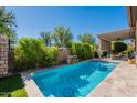 Inviting private pool with stone surround, lush greenery, and covered patio area at 35756 N Clementine Trl, San Tan Valley, AZ 85140