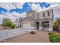 Exterior showcasing the home's stucco facade, landscaping, and driveway with a blue sky background at 4205 W Maggie Dr, San Tan Valley, AZ 85144
