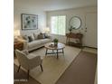 Bright living room featuring neutral tones, stylish decor, and ample natural light at 5139 E Tano St, Phoenix, AZ 85044