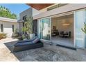 An outdoor lounge area with a chaise and an expansive sliding door that provides access to the living room at 523 W Vista Ave, Phoenix, AZ 85021