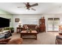 Comfortable living room featuring a large sofa, wooden coffee table, and a television at 6337 E Evergreen St, Mesa, AZ 85205