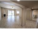 Spacious open-concept living room with tile flooring, fireplace, and seamless transition to kitchen at 6721 E Phelps Rd, Scottsdale, AZ 85254