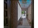 Covered entryway showing the walkway to front door and desert landscape beyond at 6721 E Phelps Rd, Scottsdale, AZ 85254