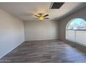 Bright living room with new floors, modern ceiling fan and large window with pleasant views at 8115 N 56Th Ave, Glendale, AZ 85302