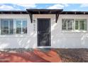 Close-up of the entryway featuring a secure screen door, decorative lighting, and stylish details at 830 E Orchid Ln, Phoenix, AZ 85020