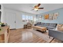 Cozy living room with comfortable seating, wood floors, and an inviting atmosphere enhanced by bright light at 830 E Orchid Ln, Phoenix, AZ 85020