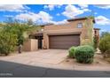 Exterior view of home showing the garage and well-maintained landscaping at 9270 E Thompson Peak Pkwy # 367, Scottsdale, AZ 85255