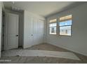 Bright bedroom featuring two windows and a closet with sliding doors, creating a cozy and inviting atmosphere at 9539 W Parkway Dr, Tolleson, AZ 85353