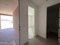 Bright entryway showcasing doorways to a bedroom, bathroom, and covered bricked patio at 9539 W Parkway Dr, Tolleson, AZ 85353