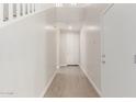 Bright entryway featuring wood-look tile flooring, white walls, and staircase access at 10229 N 49Th Dr, Glendale, AZ 85302