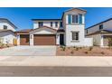 Charming two-story home with a three-car garage, a welcoming entryway, and desert landscaping at 10229 N 49Th Dr, Glendale, AZ 85302