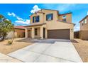 Attractive two-story home with a spacious driveway, desert landscaping, and classic architectural details at 1176 N 169Th Ave, Goodyear, AZ 85338