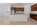 Modern kitchen featuring a large island with granite countertops and stainless steel appliances at 12327 W Luxton Ln, Avondale, AZ 85323