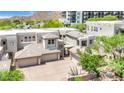 View of this luxurious home featuring a well-manicured lawn, tiled roof, and multiple garage spaces at 14850 E Grandview Dr # 204, Fountain Hills, AZ 85268