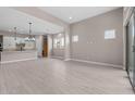 Spacious living area featuring tile flooring, recessed lighting, large windows, and an open layout to the kitchen at 22762 E Stacey Rd, Queen Creek, AZ 85142