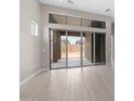 Bright living room with a large glass sliding door that leads to the backyard and light-colored tile floors at 22762 E Stacey Rd, Queen Creek, AZ 85142