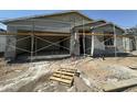New construction home with gray stucco, scaffolding, and a two-car garage at 2328 E Spur Dr, San Tan Valley, AZ 85140