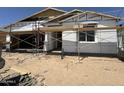 Unfinished single-story home with scaffolding and a front-facing garage at 2328 E Spur Dr, San Tan Valley, AZ 85140