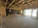 Unfinished home interior with exposed framing, sliding glass doors, and concrete floors at 2328 E Spur Dr, San Tan Valley, AZ 85140