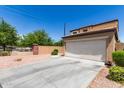 Tan two-story home with a two-car garage and concrete driveway at 2565 E Southern Ave # 130, Mesa, AZ 85204