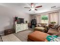 Cozy living room featuring a ceiling fan, a television, and comfortable seating at 2565 E Southern Ave # 130, Mesa, AZ 85204