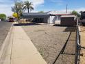 Side view of well-maintained property with covered parking and extra storage unit at 3127 N 38Th Dr, Phoenix, AZ 85019
