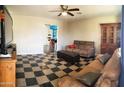 Cozy living room featuring a comfortable seating arrangement and checkerboard tile floor at 3127 N 38Th Dr, Phoenix, AZ 85019