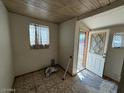 Small entryway with tiled floors, a window, and a white front door with diamond-shaped glass panes at 3155 E Mobile Ln, Phoenix, AZ 85040
