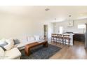 Bright living area with hardwood floors, open to the modern kitchen with island seating at 5328 E Yale St, Phoenix, AZ 85008