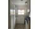 A kitchen with white cabinets, a window, and a checkered valance at 653 W Guadalupe Rd # 2019, Mesa, AZ 85210