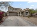 Charming two-story home with a well-manicured front yard and a spacious driveway at 69 W Grey Stone St, San Tan Valley, AZ 85143