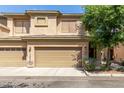 Charming townhome featuring a two-car garage and neutral stucco, complemented by mature landscaping at 705 W Queen Creek Rd # 2126, Chandler, AZ 85248