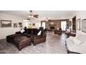 Spacious living room with exposed brick and comfortable leather furniture at 7537 W Bluefield Ave, Glendale, AZ 85308
