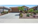 Charming single story home featuring desert landscaping, a red tile roof, and attached two-car garage at 8419 S 164Th Dr, Goodyear, AZ 85338