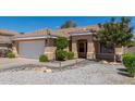 Charming single-story home featuring desert landscaping, an attached two-car garage and covered entryway at 960 W Hudson Way, Gilbert, AZ 85233