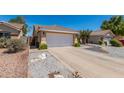 Charming single-story home featuring desert landscaping, large driveway and an attached two-car garage at 960 W Hudson Way, Gilbert, AZ 85233