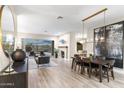 Open-concept living room with fireplace, dining area, and access to the pool area at 10478 E Sheena Dr, Scottsdale, AZ 85255